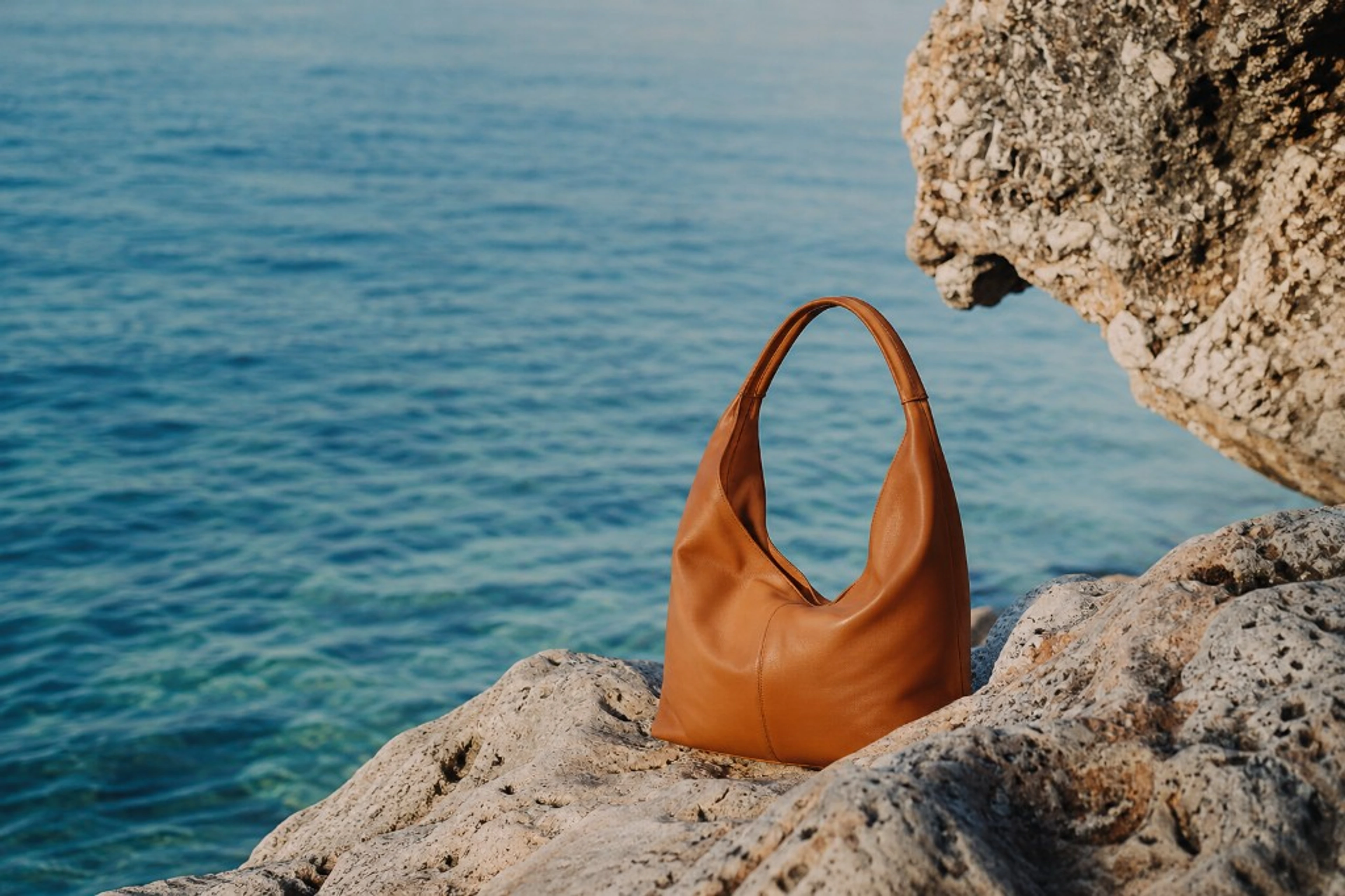 Summer Edit collection — leather handbag by the sea